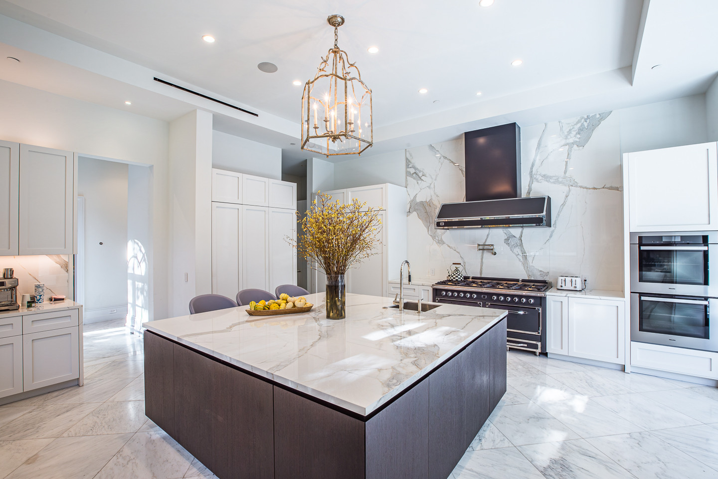 Designer gourmet kitchen with marble island and premium appliances inside a Los Angeles luxury estate rental.