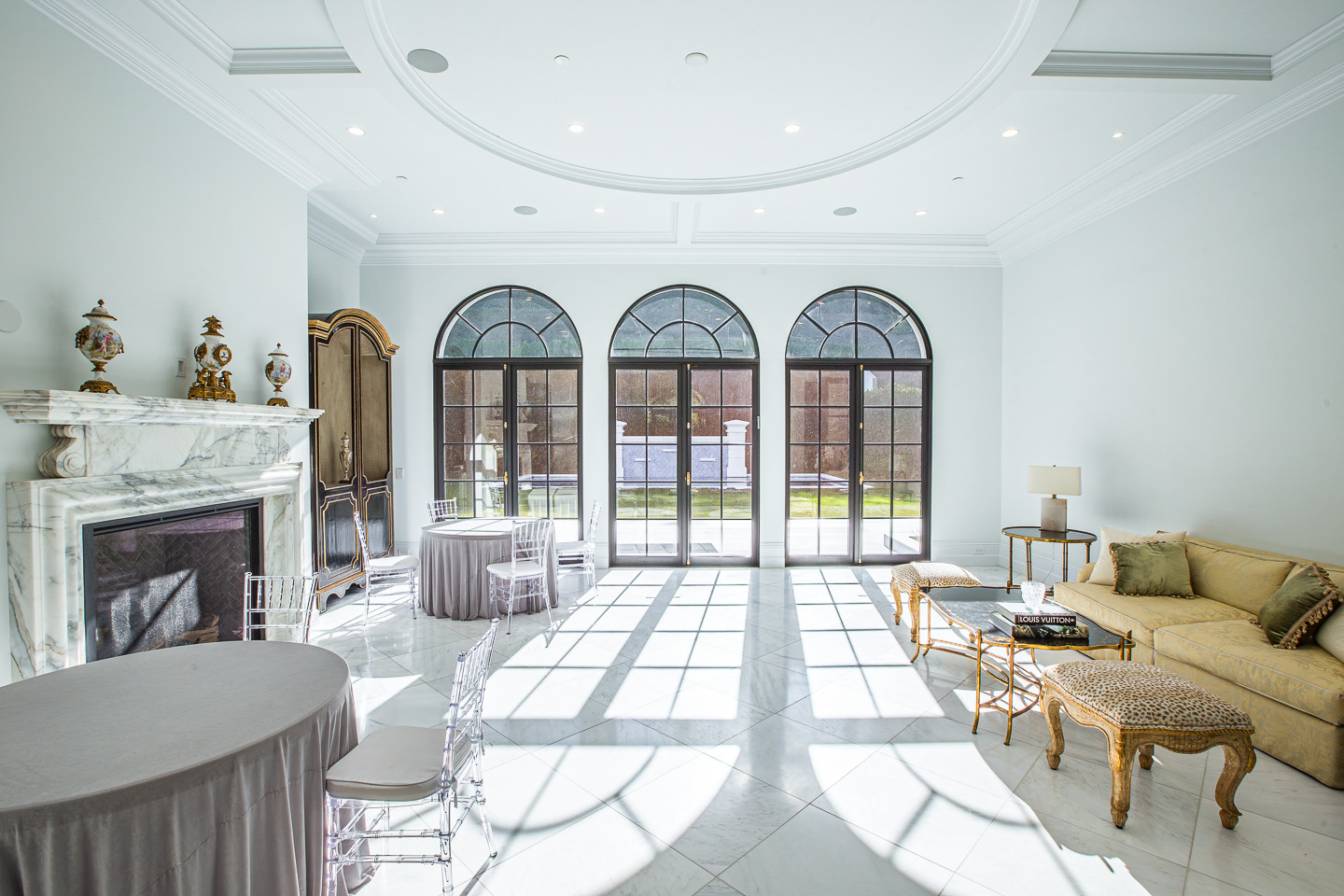 Elegant formal salon with marble fireplace and French doors inside a luxury Los Angeles estate rental.
