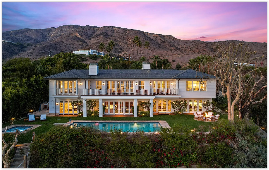 Ocean-facing exterior of an elegant Malibu estate overlooking beautifully landscaped grounds.