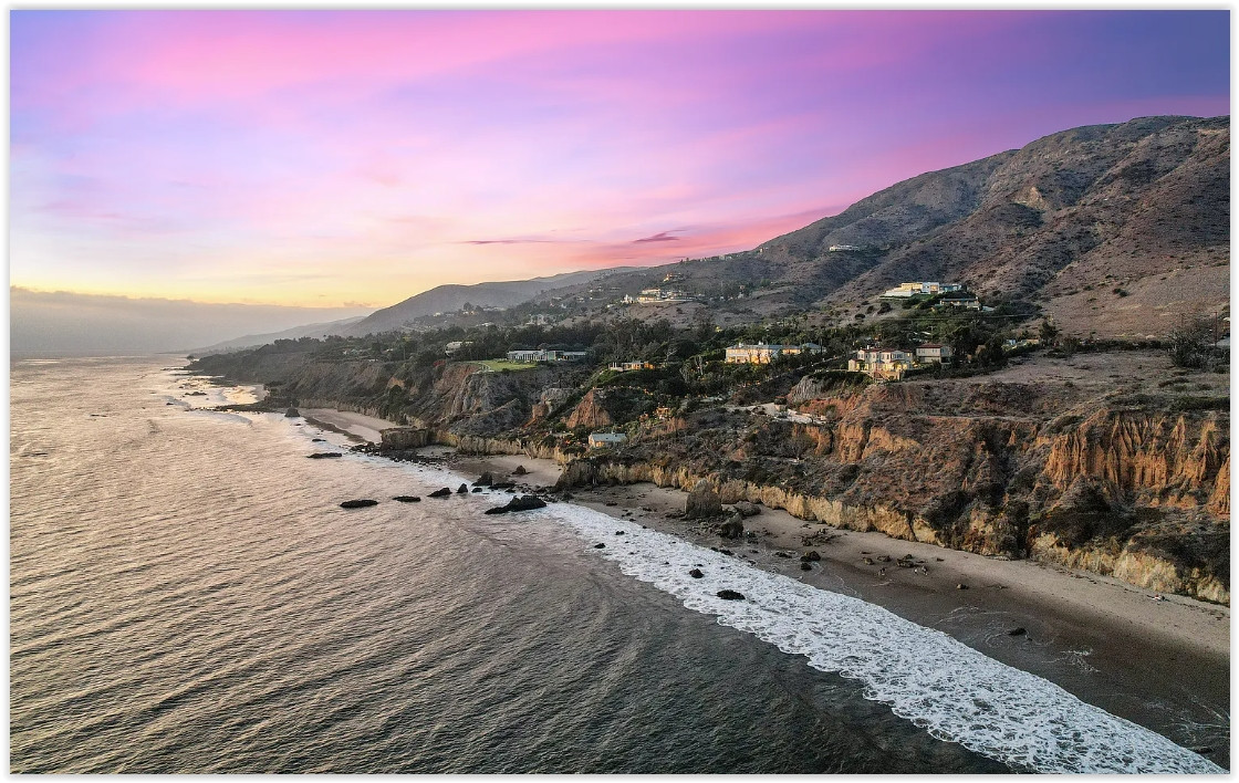 Panoramic view of the Malibu coastline surrounding an elegant private estate.