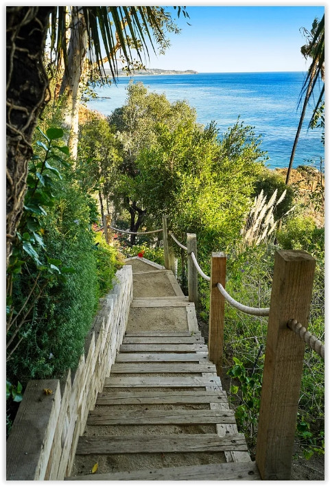 Private steps leading from an elegant Malibu estate to the beach and Pacific Ocean.