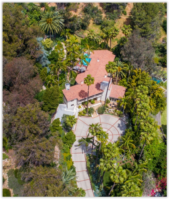 Aerial view showcasing the secluded Los Feliz estate surrounded by mature trees, gardens, and private grounds.
