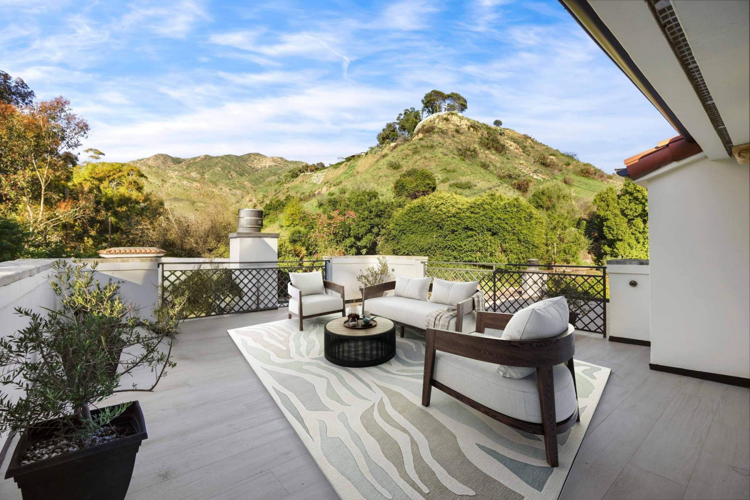 Private outdoor terrace with comfortable seating overlooking the scenic Malibu canyon and surrounding hillsides.