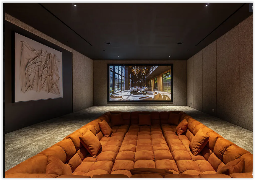 Luxury home theater with oversized sectional seating and cinematic viewing experience in a contemporary Los Angeles estate.
