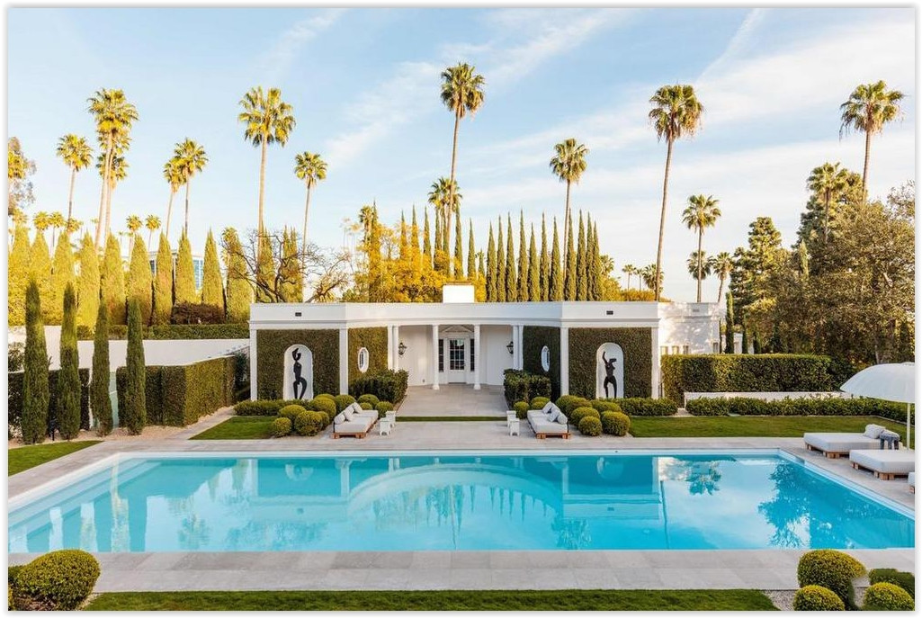 Classic Beverly Hills estate featuring a resort-style swimming pool, manicured gardens, towering palm trees, and timeless architecture.