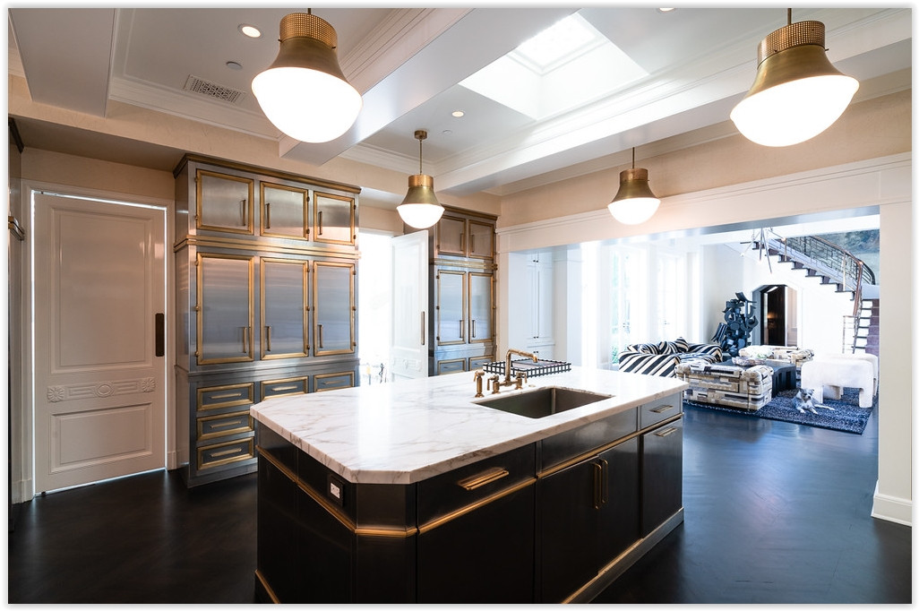 Designer gourmet kitchen with marble island, custom cabinetry, and seamless flow into the living spaces.