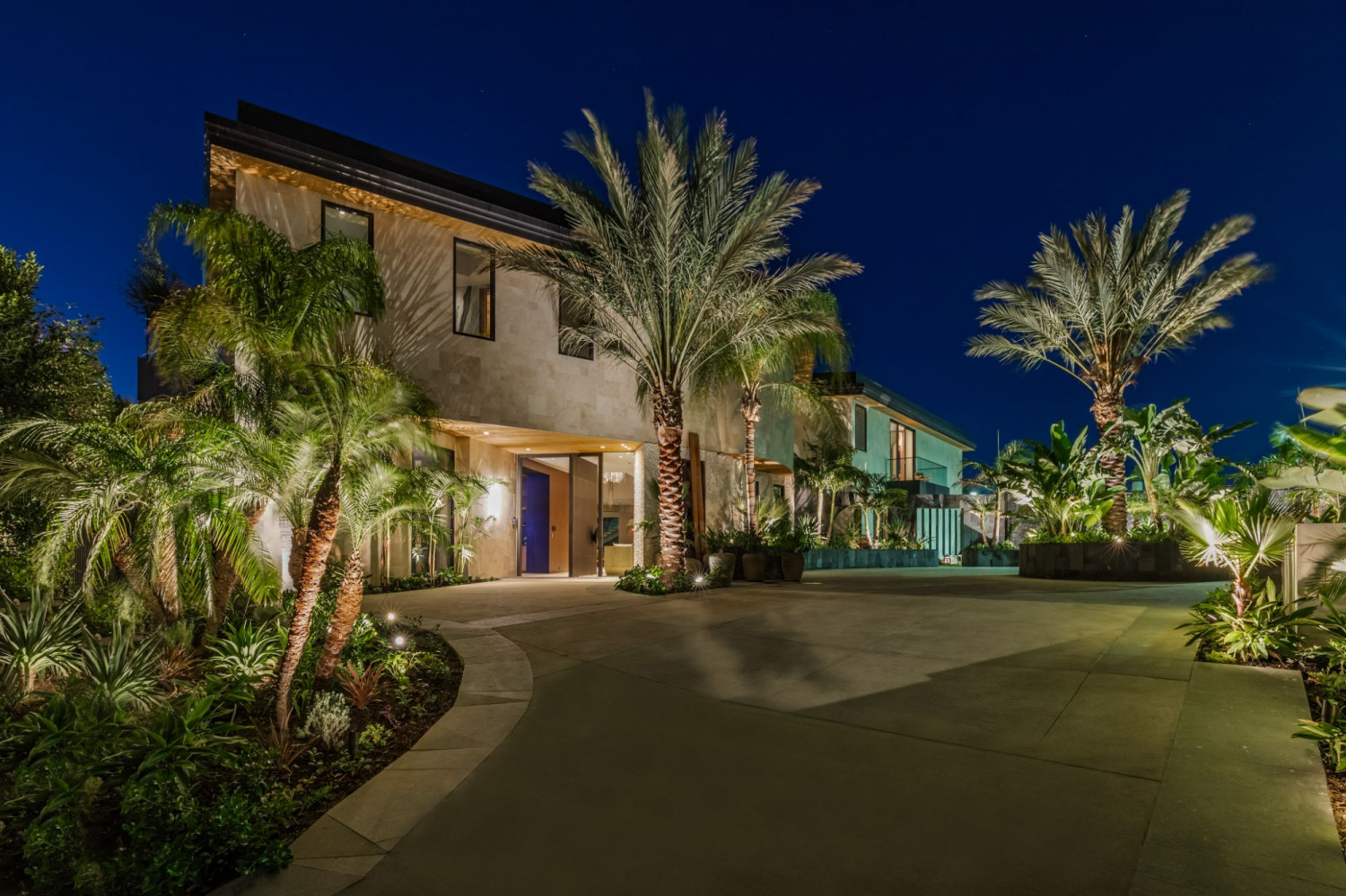 Modern Beverly Hills home with clean architectural lines, floor-to-ceiling glass, and luxury landscaping.