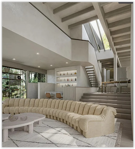 Open-concept great room with soaring ceilings, floating staircase, designer furnishings, and abundant natural light in a modern Malibu estate.