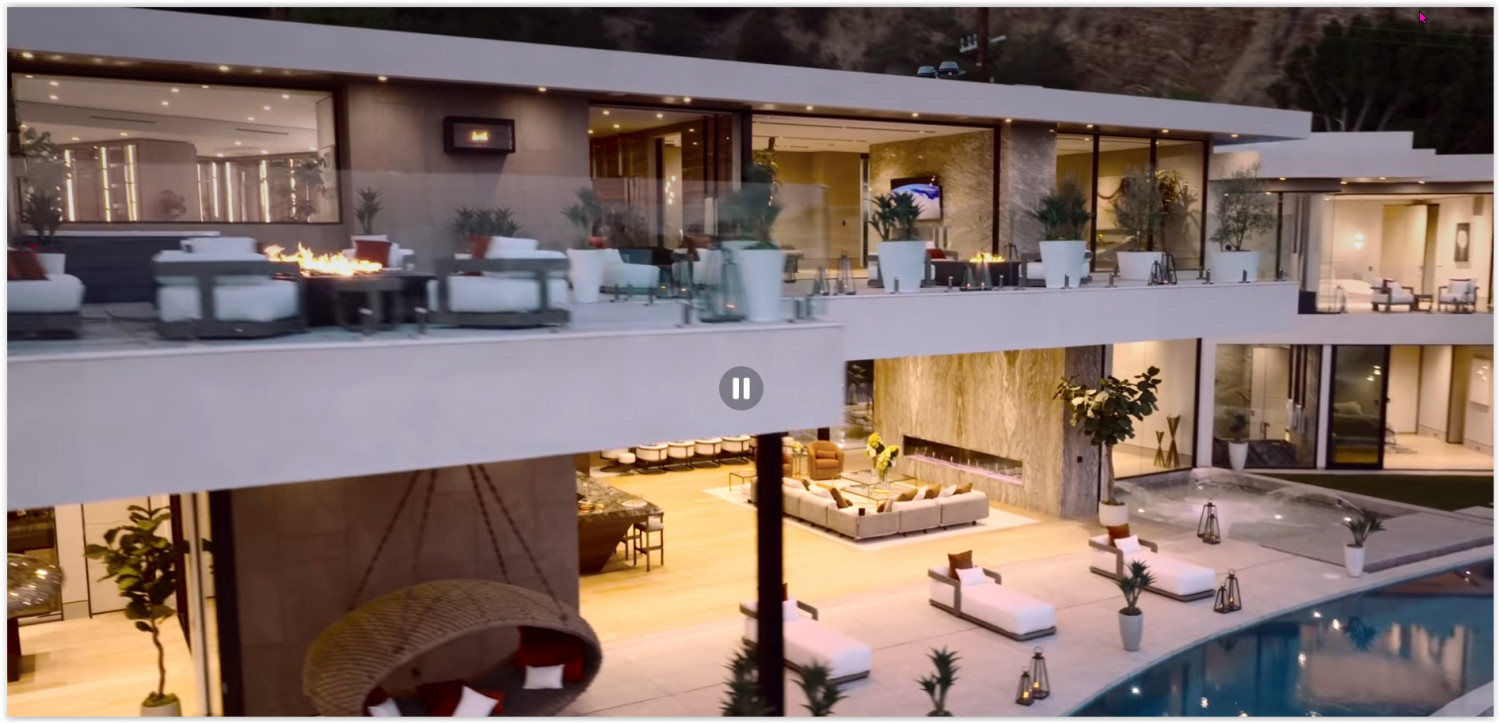 Modern Los Angeles estate at twilight featuring multiple entertaining levels, an infinity pool, and panoramic city views
