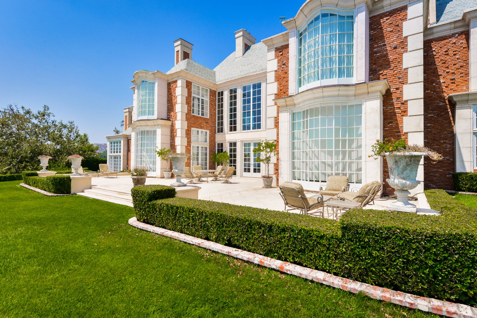 Expansive rear terrace overlooking manicured gardens at a private Pasadena estate.
