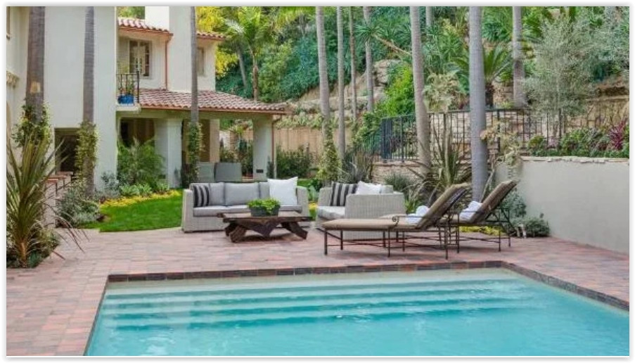 Private swimming pool surrounded by lush gardens and outdoor lounge areas at a romantic Los Feliz estate.