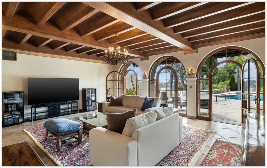 Elegant living room featuring exposed wood beam ceilings, a fireplace, grand piano, and Spanish Colonial architecture. Family Room Title Family Room with Pool Access Alt Comfortable family room opening to the pool terrace through arched French doors. Formal Entry Hall Title Spanish Colonial Grand Entry Alt Grand entry hall with terracotta floors, sweeping staircase, crystal chandelier, and handcrafted architectural details. Reception Hall Title Formal Reception Hall Alt Elegant reception hall with high ceilings, terracotta floors, antique furnishings, and natural light. Formal Dining Room Title Formal Dining Room Alt Sophisticated dining room featuring terracotta flooring, crystal chandeliers, and classic Spanish Colonial details. Formal Lawn Title Expansive Estate Lawn Alt Large manicured lawn surrounded by mature trees, ideal for private outdoor gatherings. Estate Grounds Title Private Estate Grounds Alt Beautifully landscaped grounds with mature trees, open lawns, and peaceful garden spaces. Tree-Lined Drive Title Private Tree-Lined Driveway Alt Private tree-lined driveway leading to a secluded Spanish Colonial estate. Recommended Gallery Order Hero aerial Front courtyard (day) Front courtyard (twilight) Sunset aerial Pool Covered loggia Living room Family room Grand entry Reception hall Dining room Estate lawn Estate grounds Tree-lined driveway Red Team Recommendation This estate feels historic, romantic, and timeless. Rather than emphasizing "luxury" repeatedly, position it as a Spanish Colonial estate rich in architectural character. Terms like Old World craftsmanship, Mediterranean elegance, handcrafted details, arched loggias, terracotta floors, lush grounds, and private hillside retreat will help this page stand apart from the more contemporary estates in your collection while attracting planners looking for a warm, classic California setting.