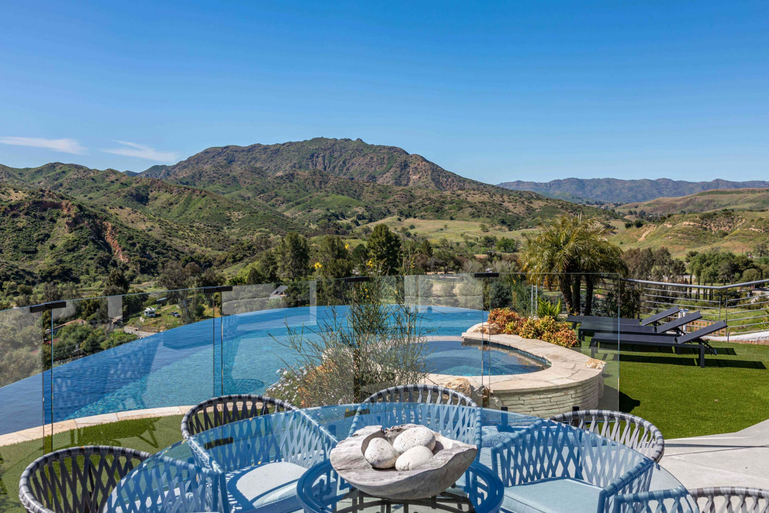 Luxury hillside estate pool overlooking canyon landscape in Agoura Hills with modern architecture and resort-style outdoor design.
