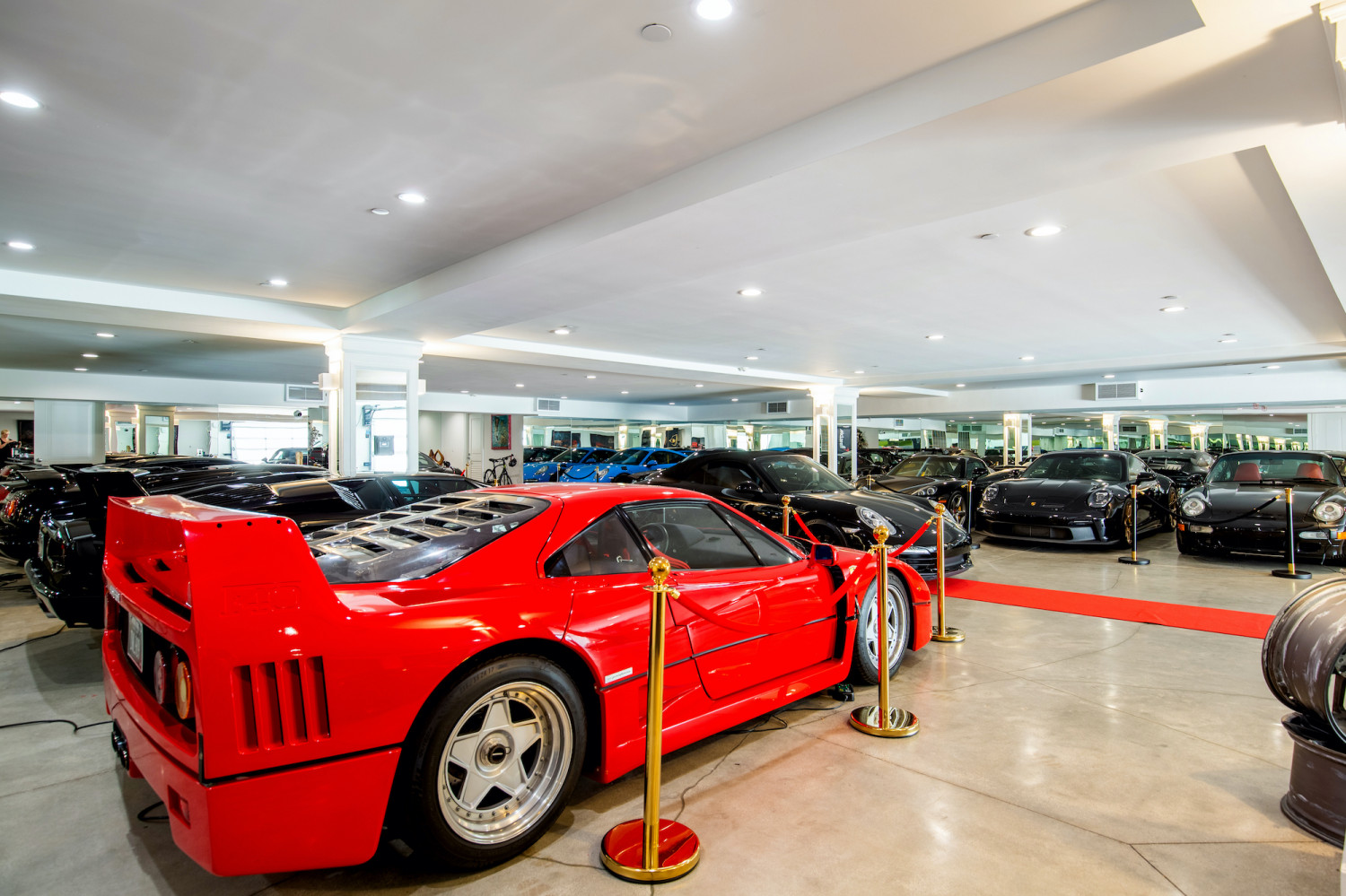 Private luxury automobile gallery featuring an exceptional collector car display inside a Modern Private Estate Home Events estate.